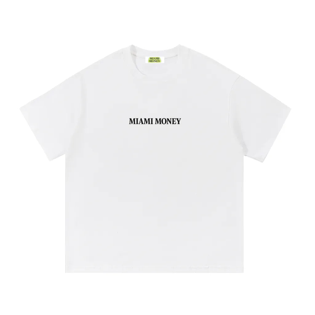Miami Money white crewneck t-shirt front view featuring a minimalist black “MIAMI MONEY” chest logo centered on the upper front—clean luxury streetwear basic with a classic short-sleeve fit on a white background.